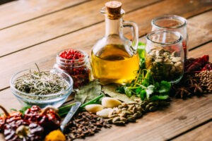 Hakkımızda 7 Assorted spices and herbs and bottle of oil placed on wooden tabletop