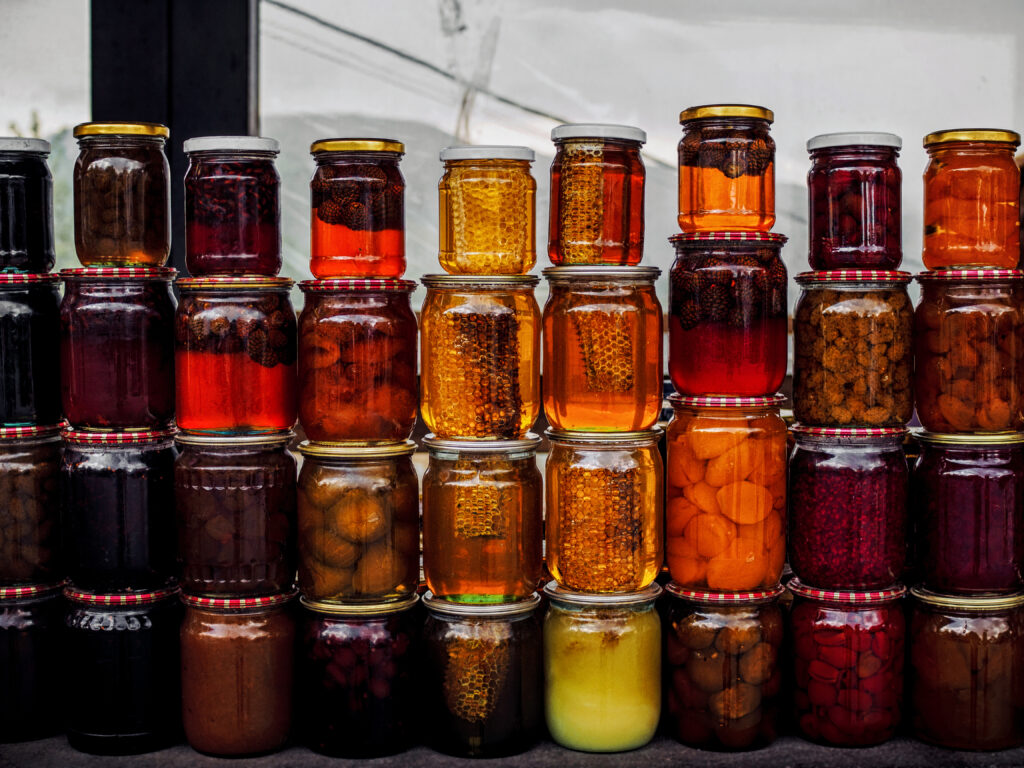 stacks of jars with honey and pickled fruits on ma 2022 12 16 20 44 00 utc